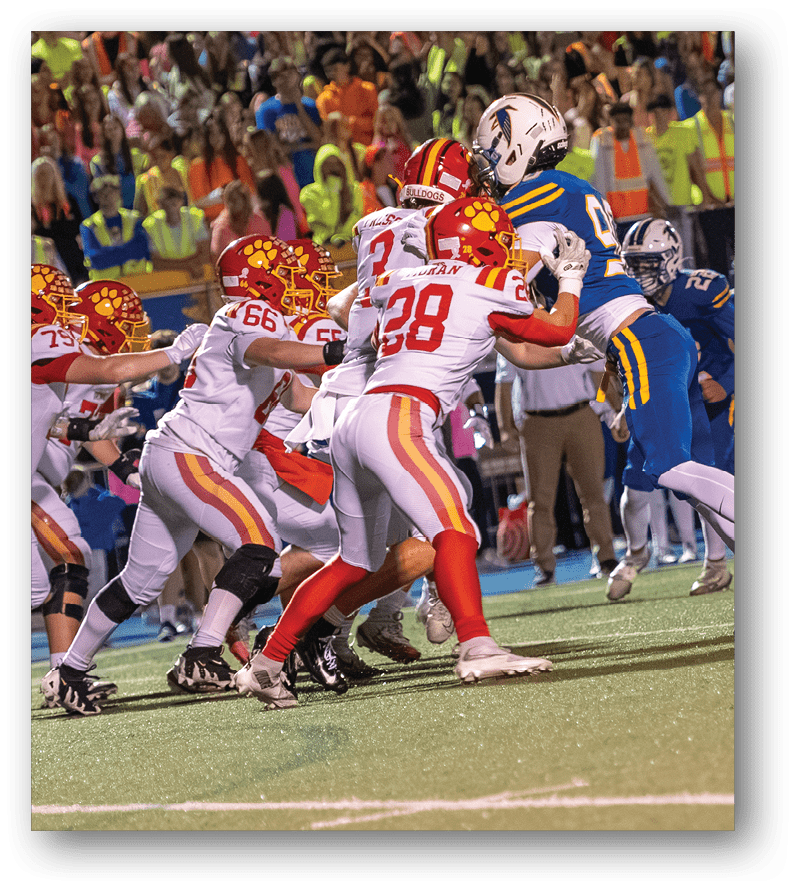 A group of football players on a field. Description generated by AI