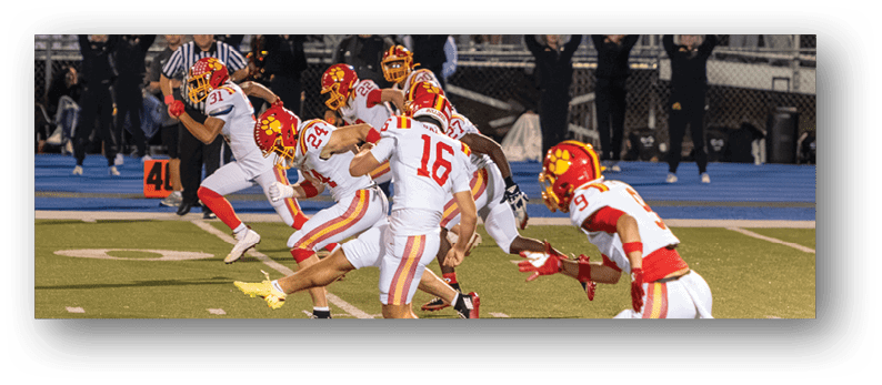 A group of football players on a field. Description generated by AI