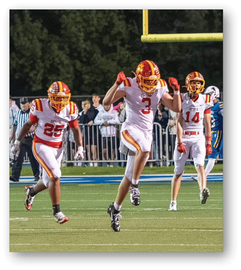 A group of football players on a field. Description generated by AI