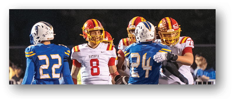 A group of football players on a field. Description generated by AI