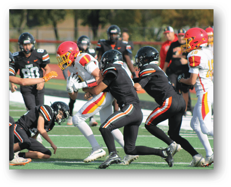 Three football players in blue and white uniforms running on a field. Description generated by AI