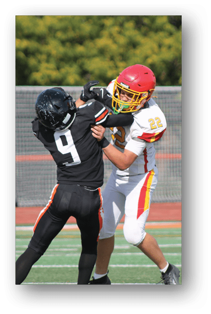 A football player catching a ball. Description generated by AI