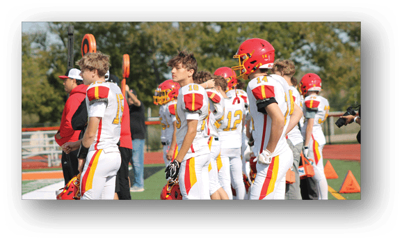 A group of football players on a field. Description generated by AI