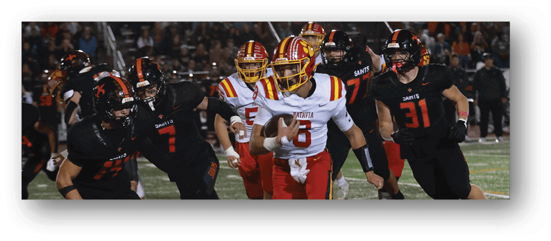 A group of football players on a field. Description generated by AI