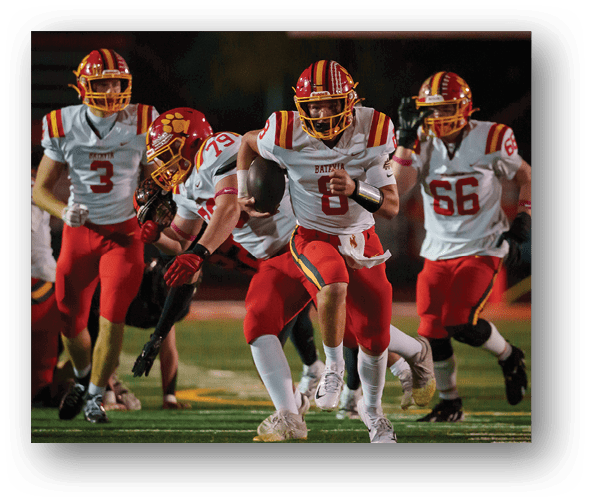 A group of football players celebrating a touchdown. Description generated by AI