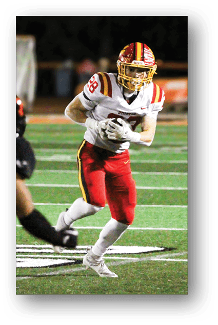 A football player catching a ball. Description generated by AI