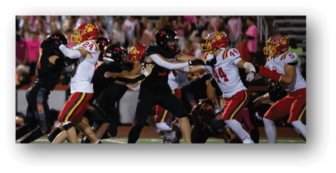 A group of football players on a field. Description generated by AI