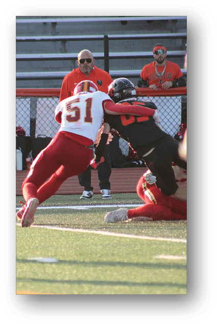 A football player catching a ball. Description generated by AI