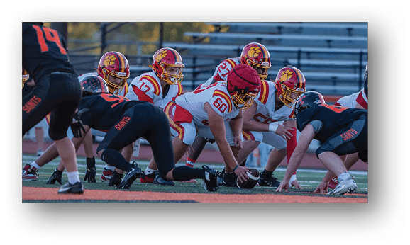 A group of football players on a field. Description generated by AI