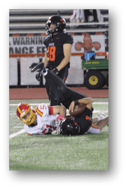A football player catching a ball. Description generated by AI