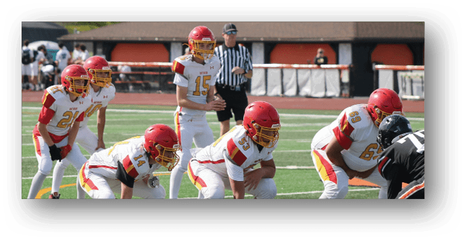 A group of football players on a field. Description generated by AI
