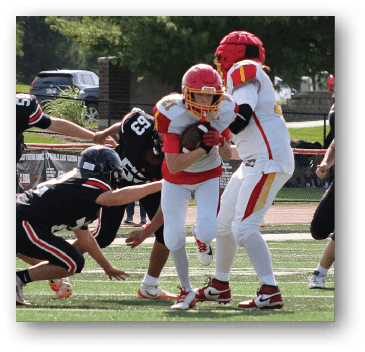 Three football players in blue and white uniforms running on a field. Description generated by AI