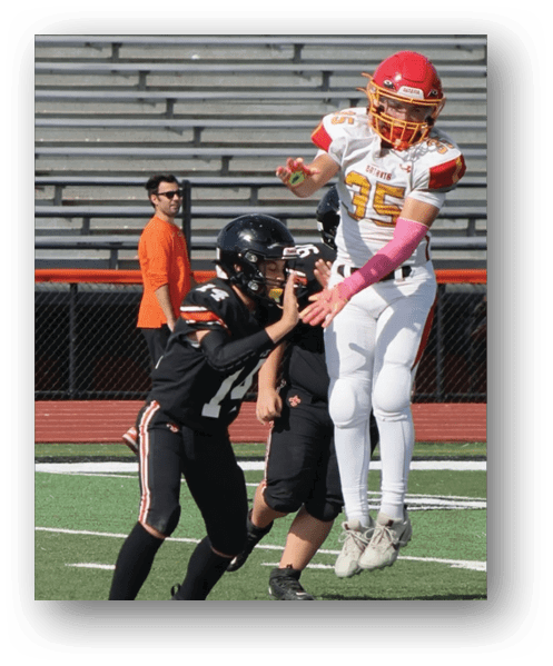 A football player catching a ball. Description generated by AI