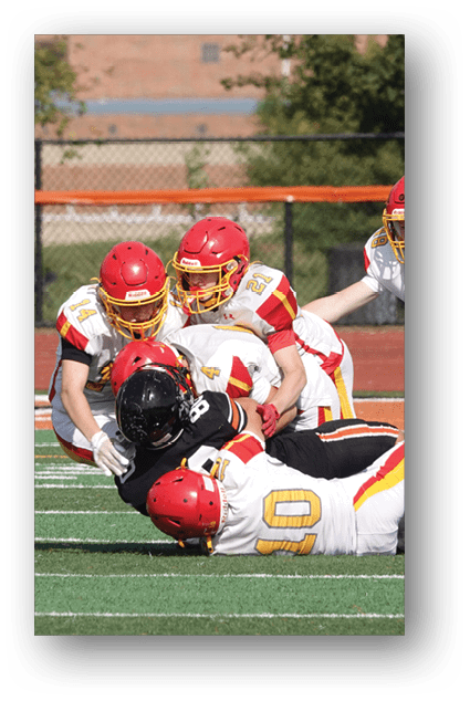 A football player catching a ball. Description generated by AI