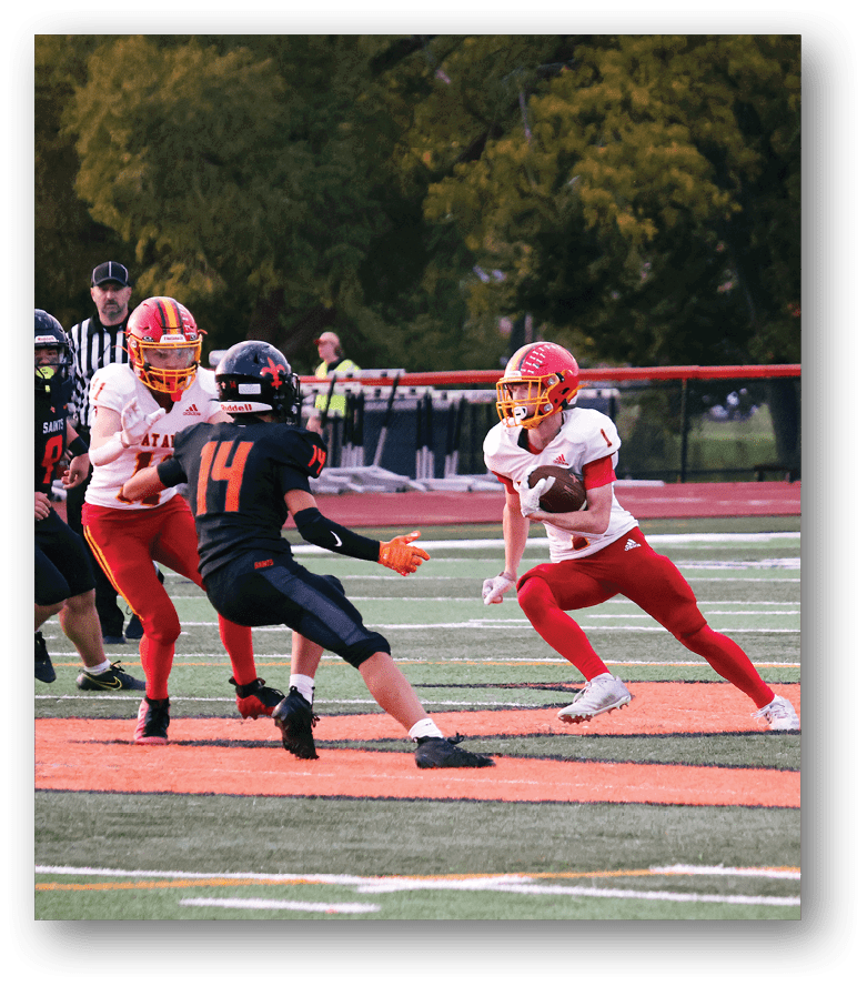 Three football players in blue and white uniforms running on a field. Description generated by AI