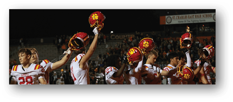 A group of football players on a field. Description generated by AI