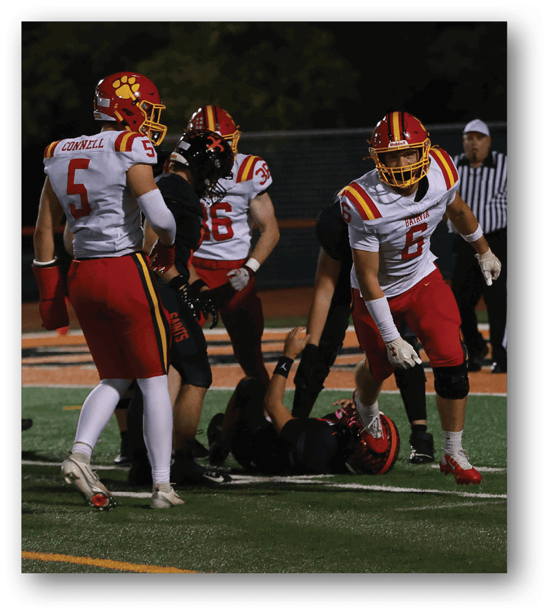 A group of football players on a field. Description generated by AI