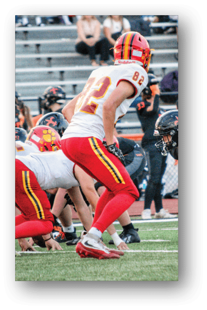 A football player catching a ball. Description generated by AI