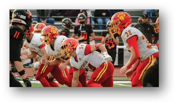 A group of football players on a field. Description generated by AI