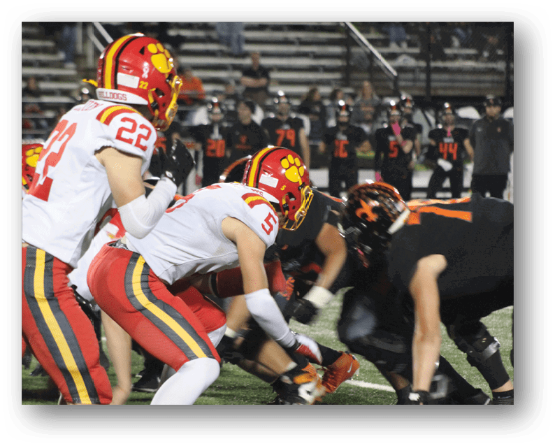 A group of football players on a field. Description generated by AI
