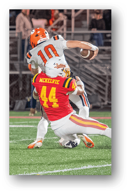 Two football players wearing blue and white uniforms. Description generated by AI
