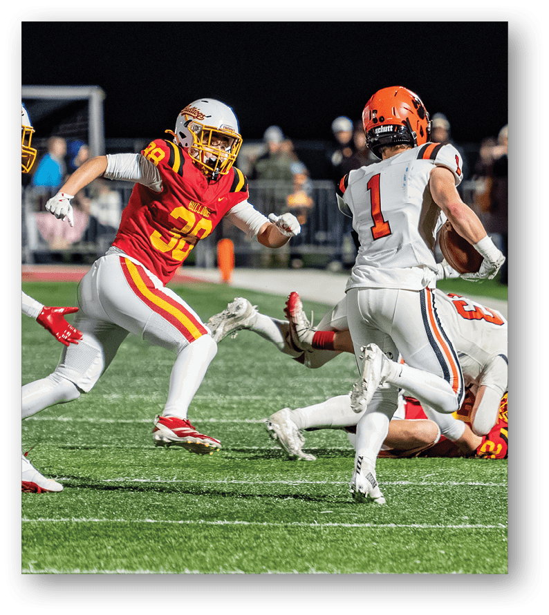 A group of football players on a field. Description generated by AI