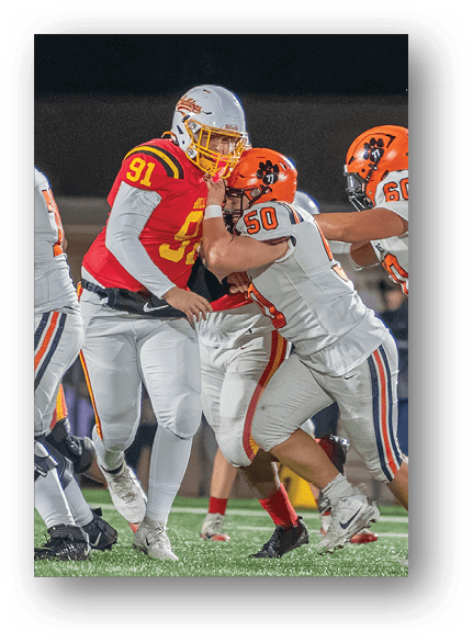 A group of football players celebrating a touchdown. Description generated by AI