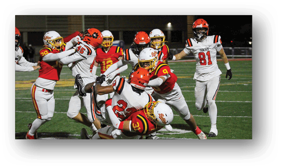 A group of football players on a field. Description generated by AI