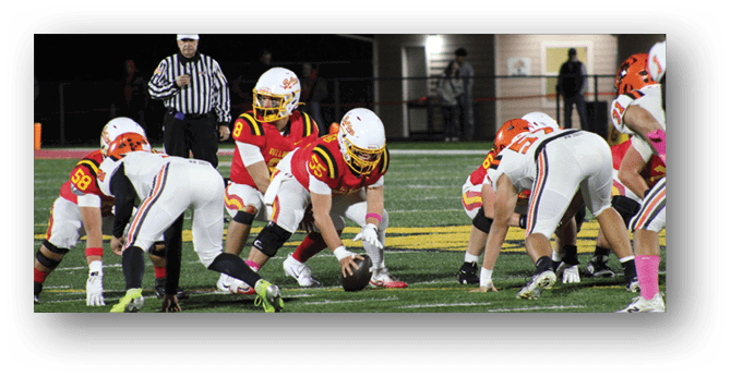 A group of football players on a field. Description generated by AI