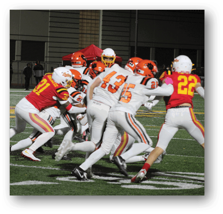 Three football players in blue and white uniforms running on a field. Description generated by AI