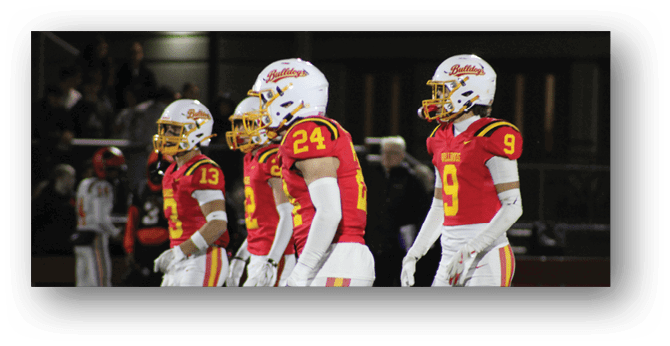 A group of football players on a field. Description generated by AI