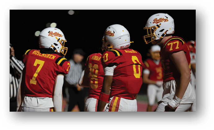 A group of football players on a field. Description generated by AI