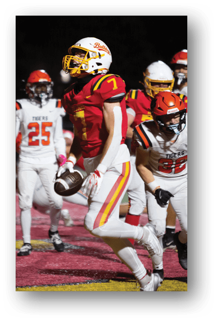 Two football players wearing blue and white uniforms. Description generated by AI