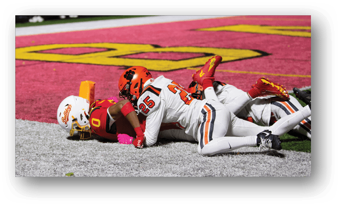A group of football players on a field. Description generated by AI