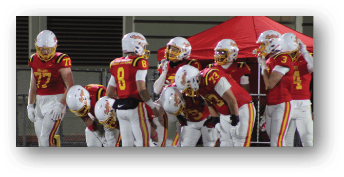 A group of football players on a field. Description generated by AI