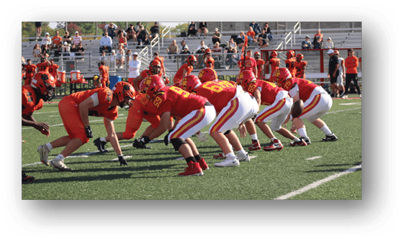 A group of football players on a field. Description generated by AI