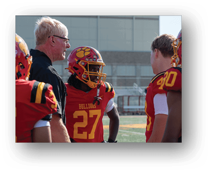 A group of football players on a field. Description generated by AI