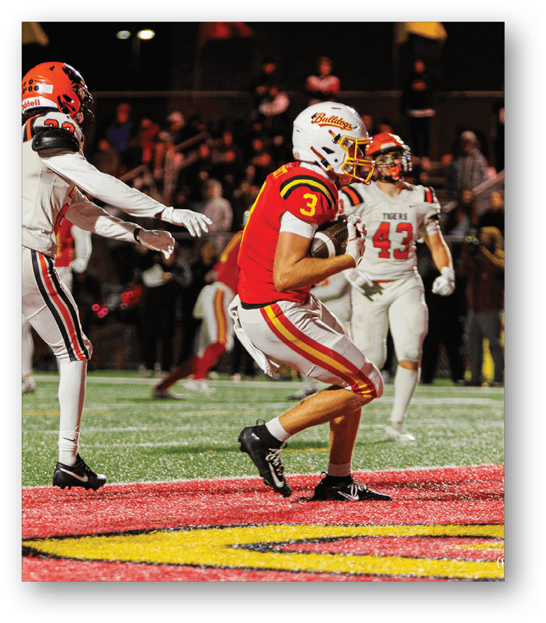A group of football players on a field. Description generated by AI