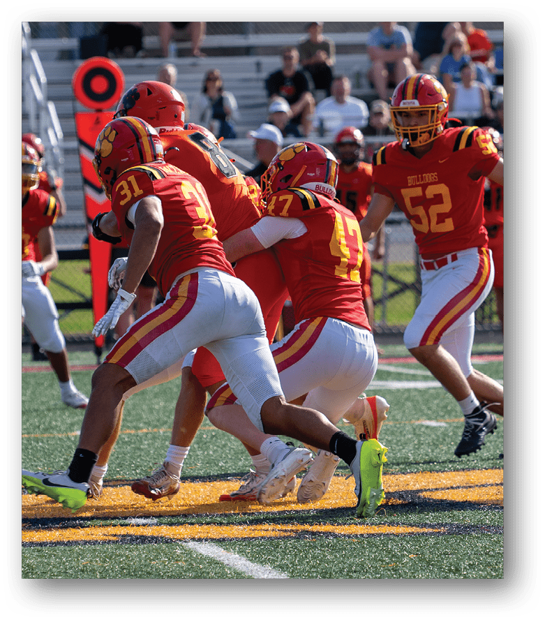 Three football players in blue and white uniforms running on a field. Description generated by AI