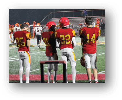A group of football players on a field. Description generated by AI