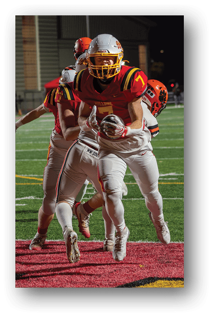 Two football players wearing blue and white uniforms. Description generated by AI