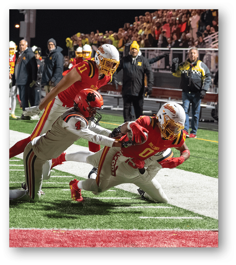 A group of football players on a field. Description generated by AI