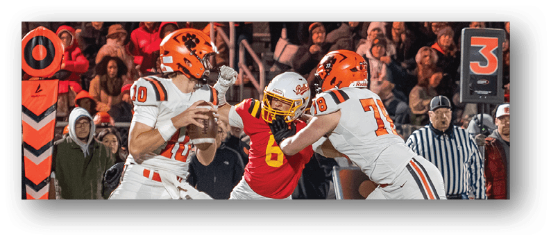 A group of football players on a field. Description generated by AI