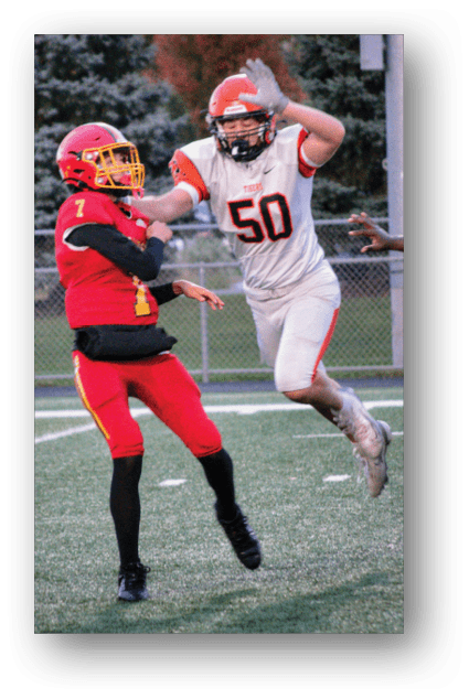 A football player catching a ball. Description generated by AI