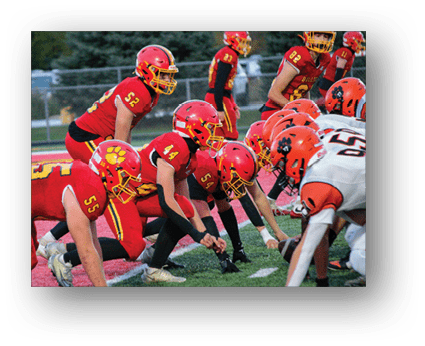 A group of football players on a field. Description generated by AI