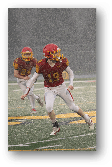 A football player catching a ball. Description generated by AI