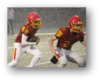 A group of football players on a field. Description generated by AI