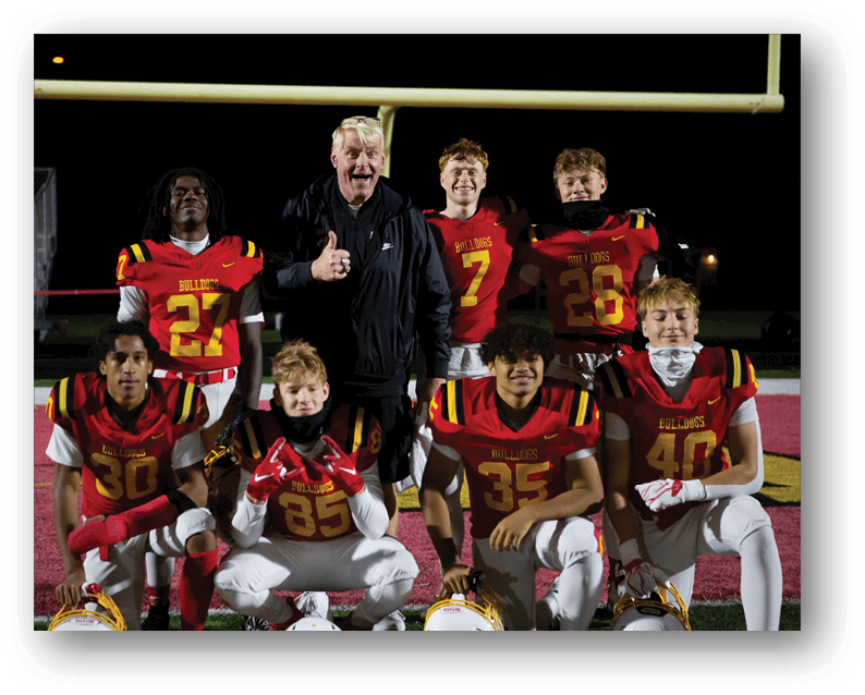A group of football players on a field. Description generated by AI