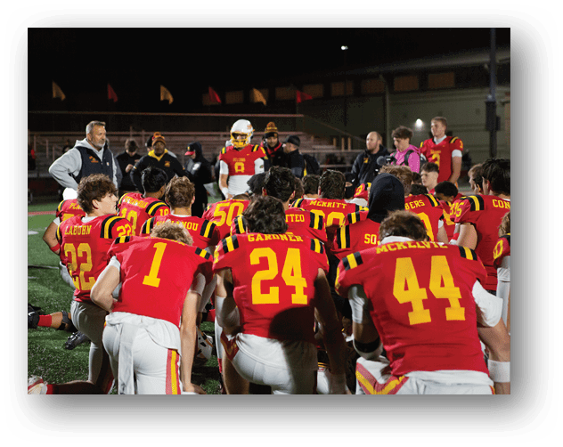 A football game is taking place on a field with players wearing blue and white uniforms. Description generated by AI