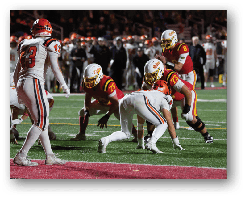 A group of football players on a field. Description generated by AI